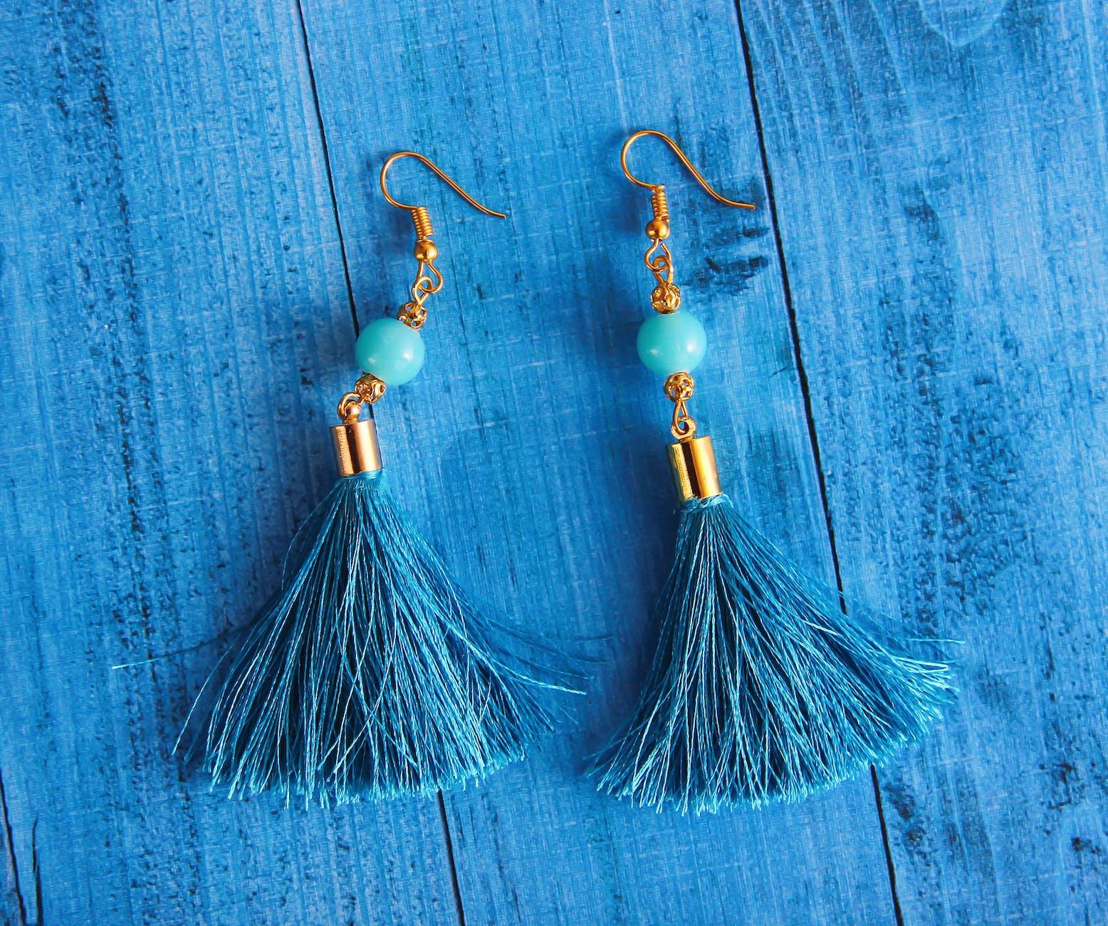 close up photography of blue earrings