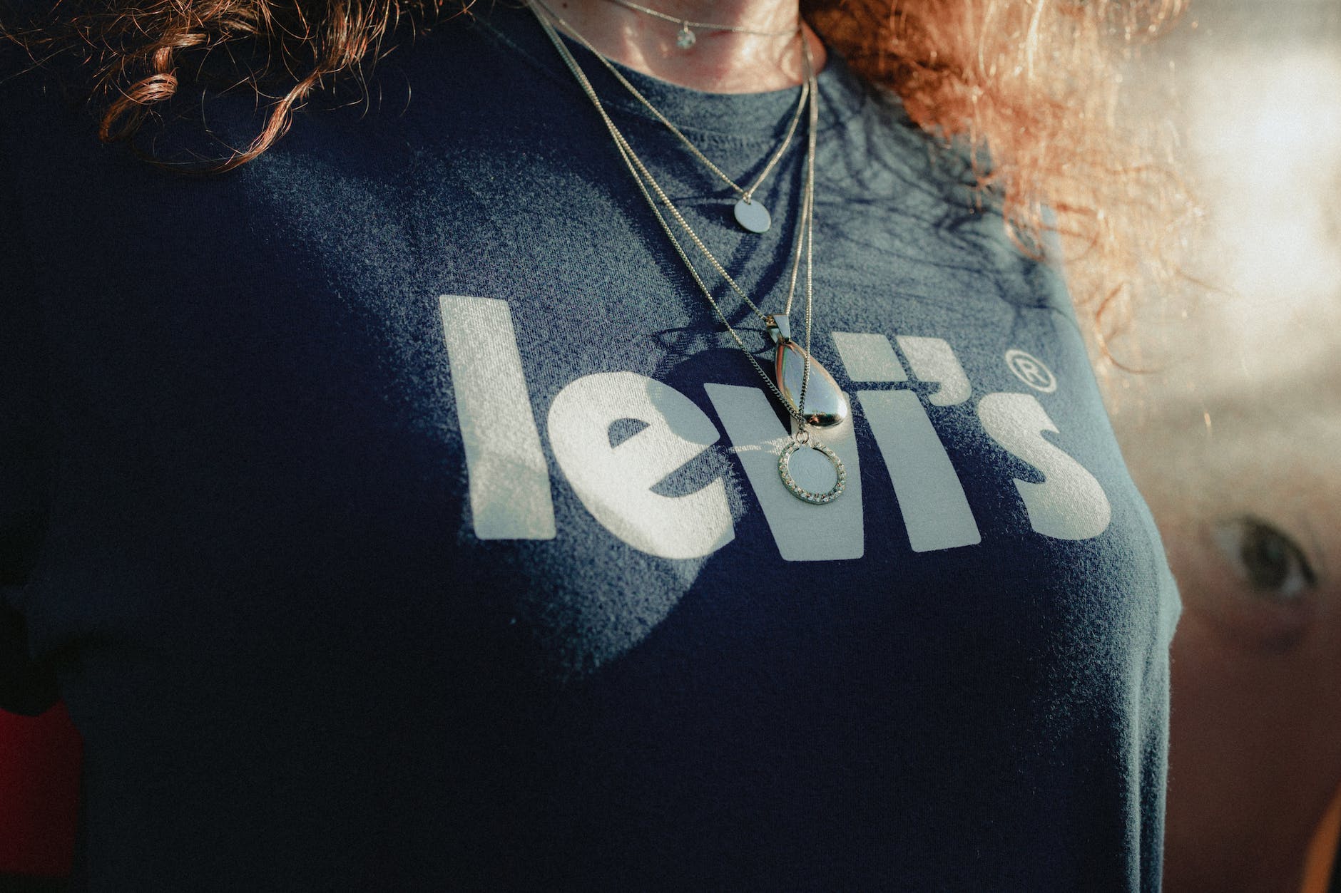 woman in black crew neck t shirt wearing necklaces