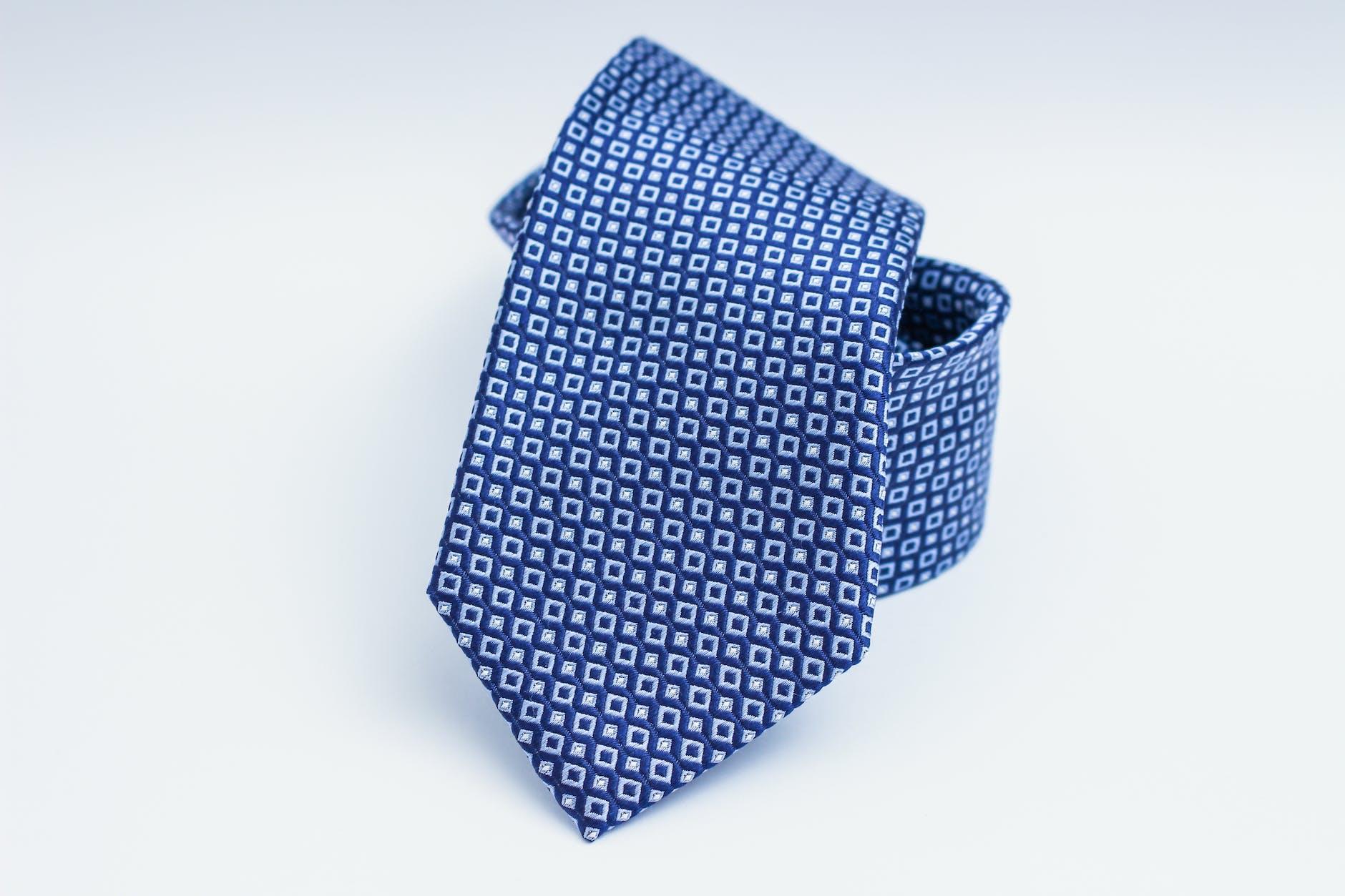 blue necktie on white surface