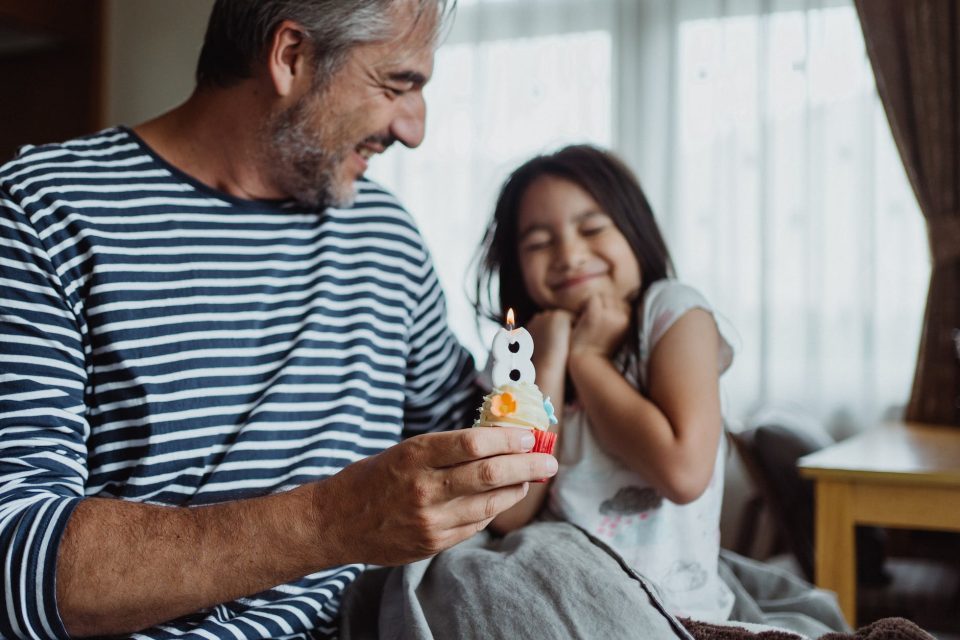 a father sitting with his daughter