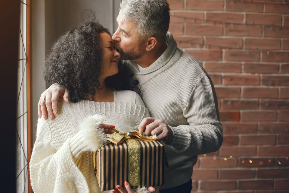 loving husband giving a christmas present to his wife